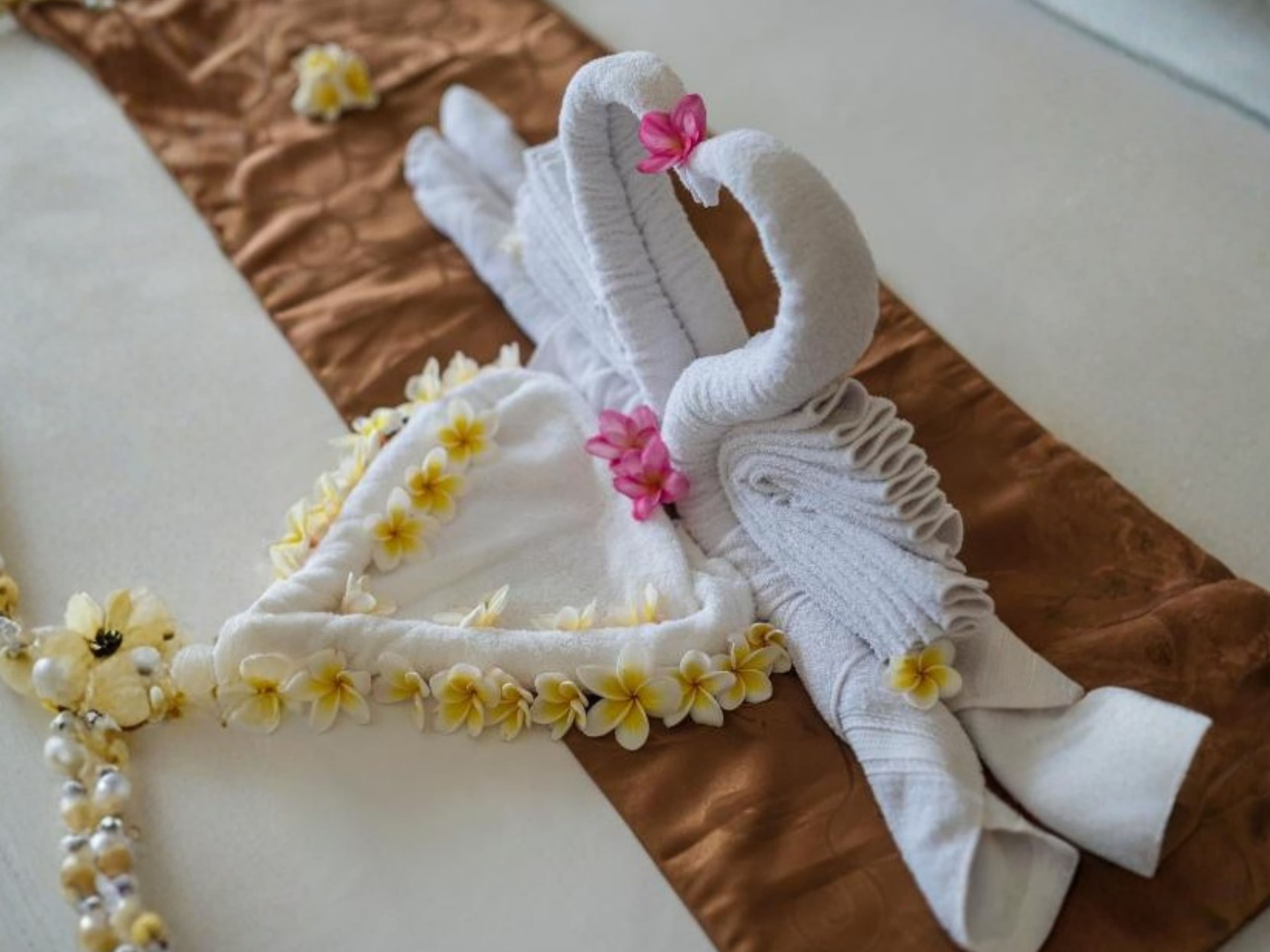 Deluxe Double Room — welcome towel art with frangipani