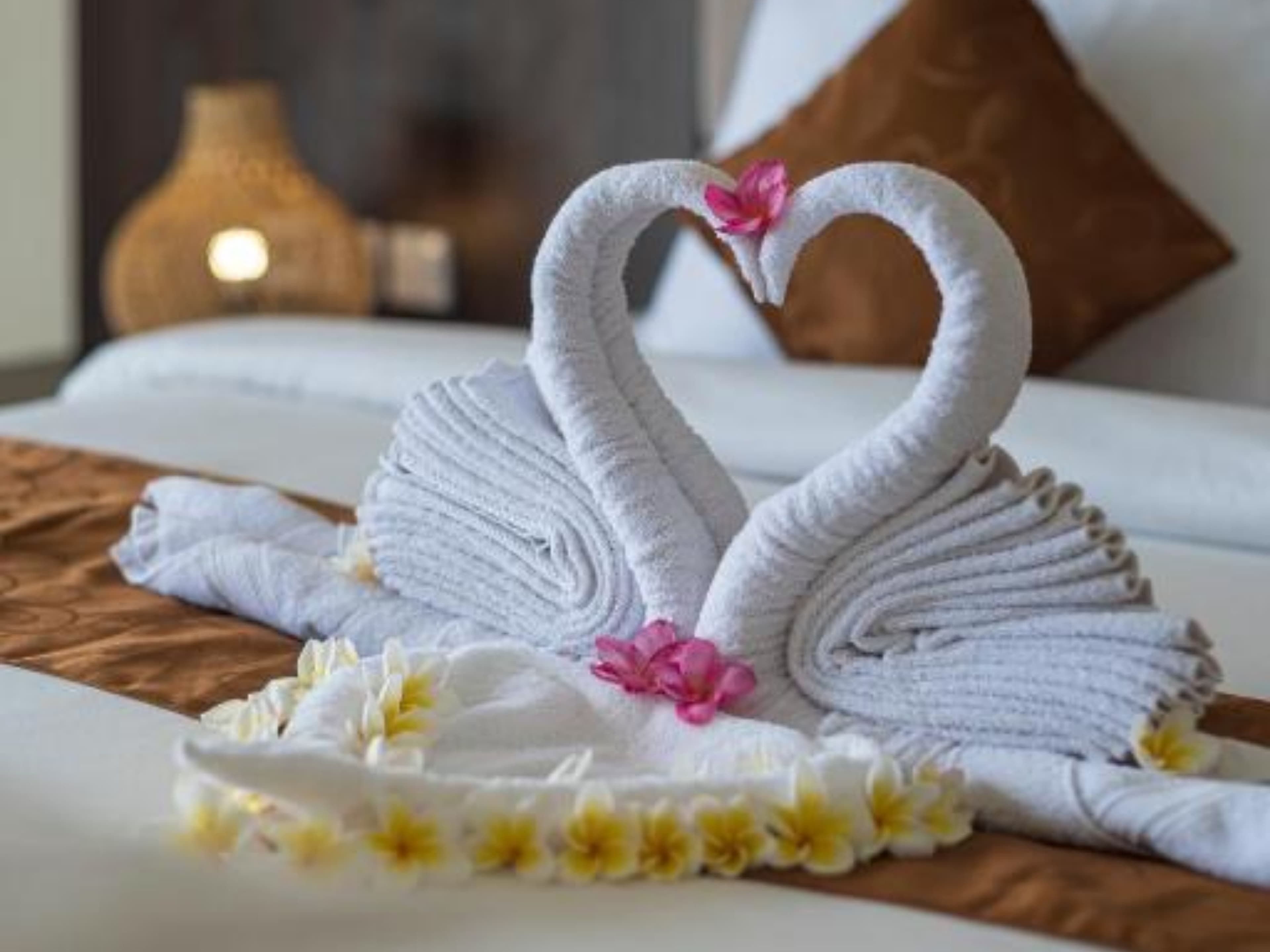 Deluxe Twin Room — welcome towel art with frangipani